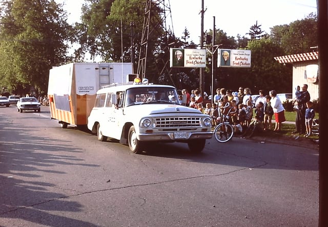 The CFCO wagon tows the cruiser trailer past parade watchers